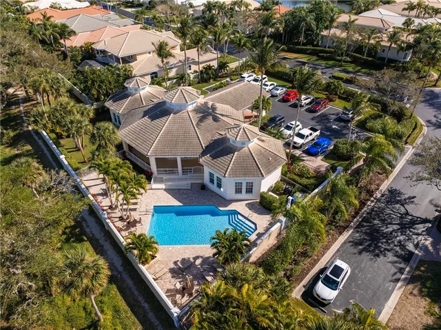 a view of a tennis ground with a large tree