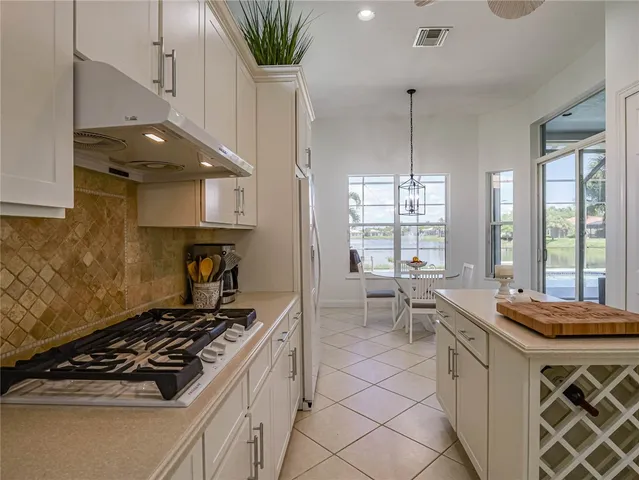 a kitchen with a stove a sink and a refrigerator