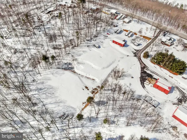 a view of swimming pool with a yard in front of it