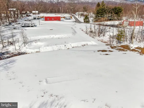 a view of a house with snow on the road
