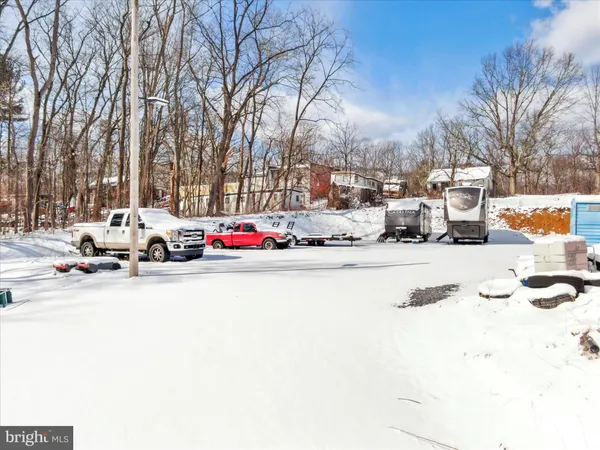 a view of a house with snow on the background