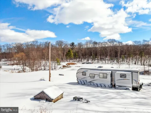 a view of a house with snow on the road