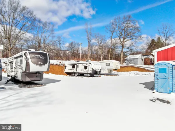 a view of a house with snow on the road
