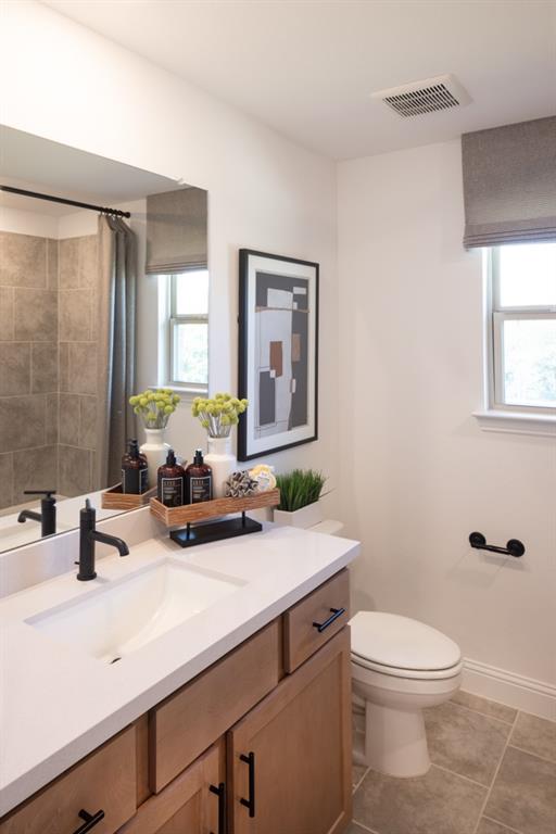 550 Wisteria Street Oak Point, TX 75068 - Photo 18 of 27 a bathroom with a sink a toilet and mirror