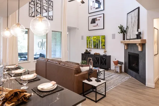 a living room with furniture kitchen view and a fireplace