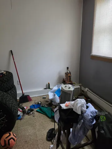 a bedroom with furniture and a window