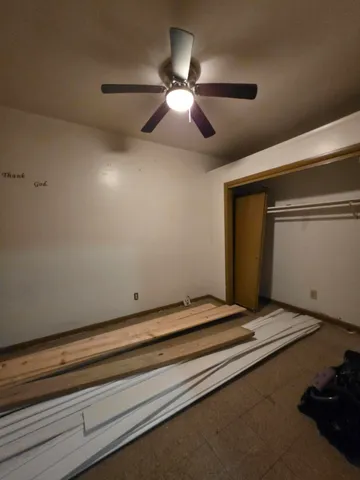 a view of room with window and ceiling fan