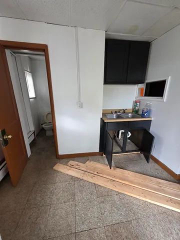 a living room with a piano and a flat screen tv