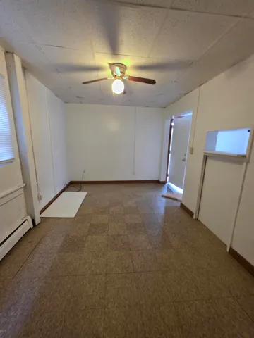 an empty room with windows and entrance