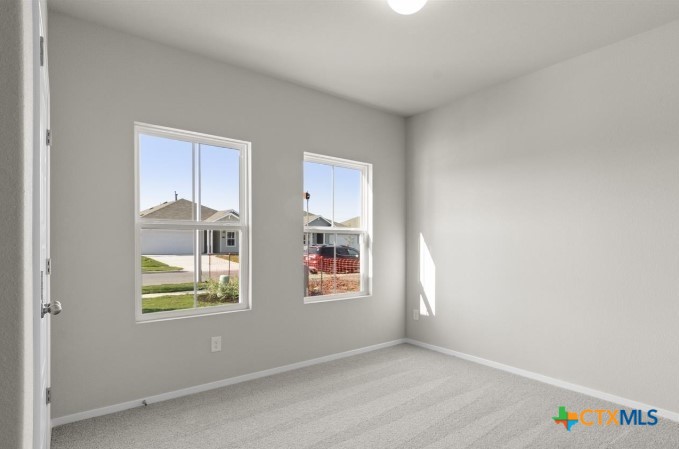 2431 Winding Creek Road Kyle, TX 78640 - Photo 16 of 29 an empty room with windows