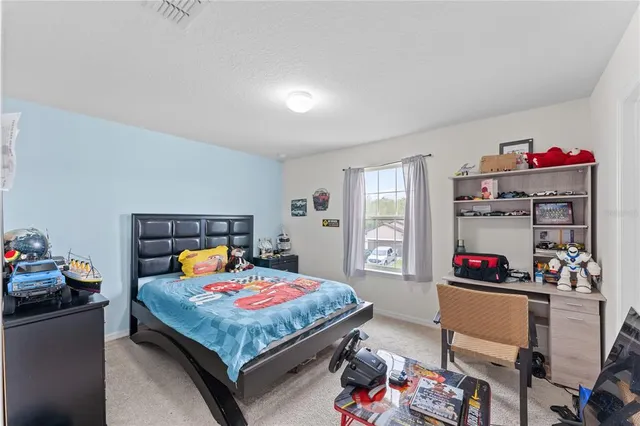 a bedroom with furniture and a flat screen tv