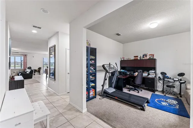 a living room with furniture a flat screen tv and a table