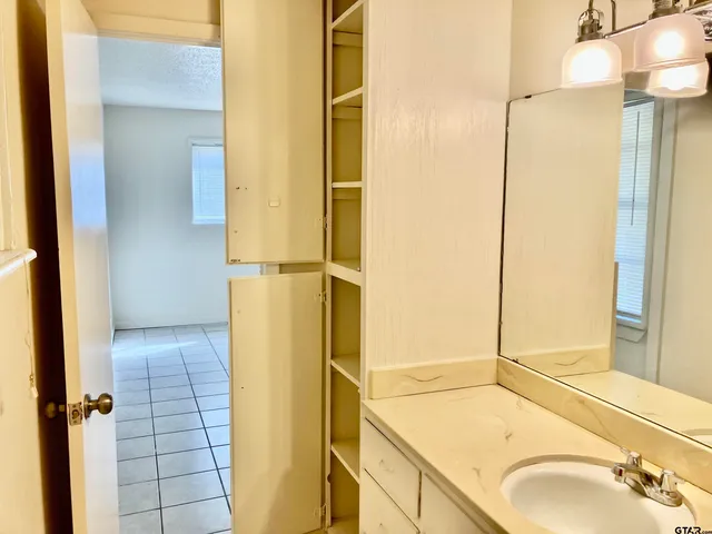 a view of a hallway with wooden shelves