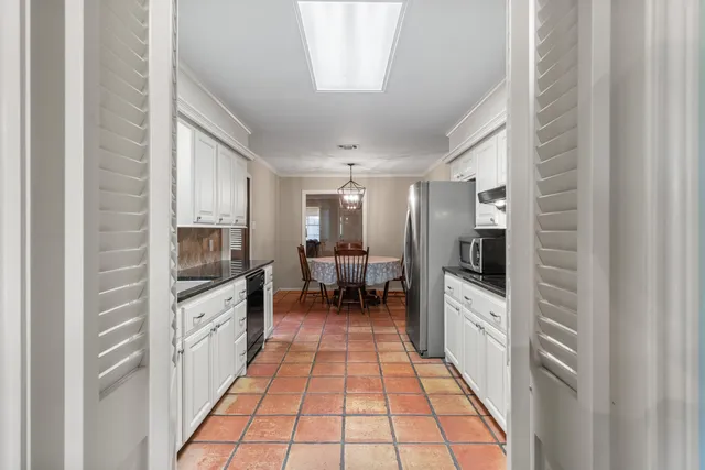 a large white kitchen with cabinets