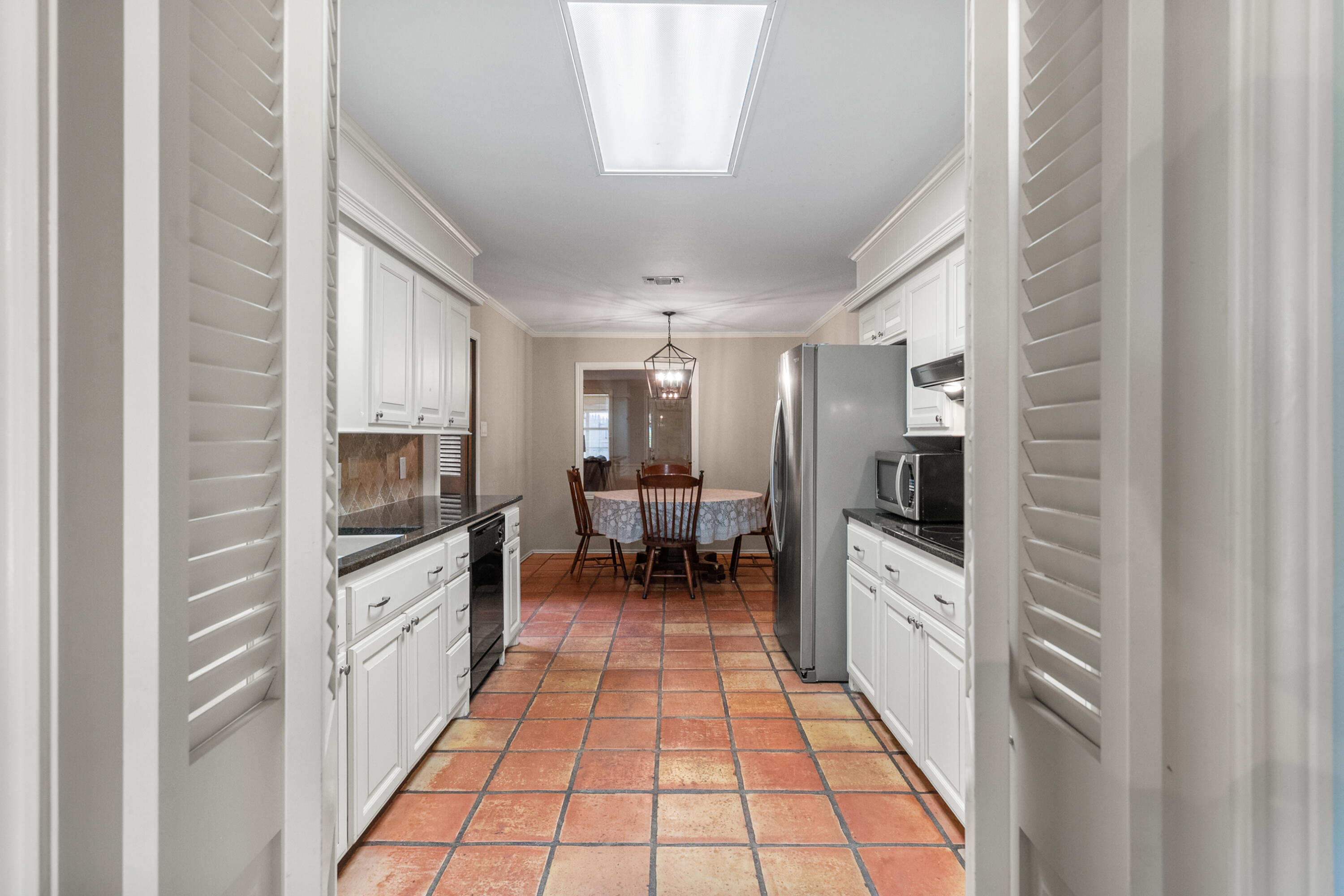 3801 66th Street Lubbock, TX 79413 - Photo 12 of 36 a large white kitchen with cabinets