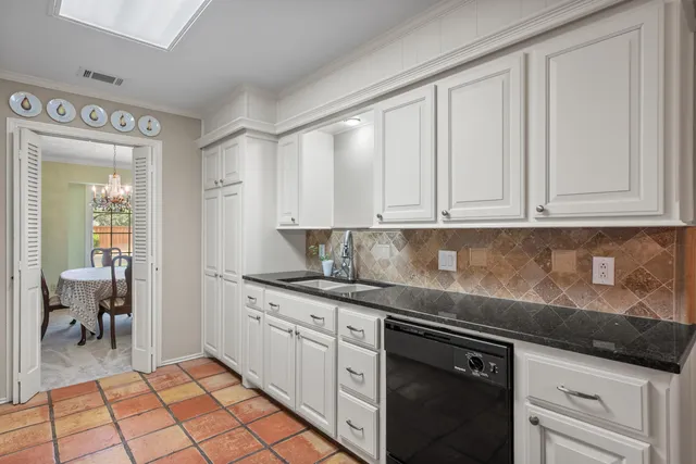 a kitchen with stainless steel appliances granite countertop a sink and cabinets