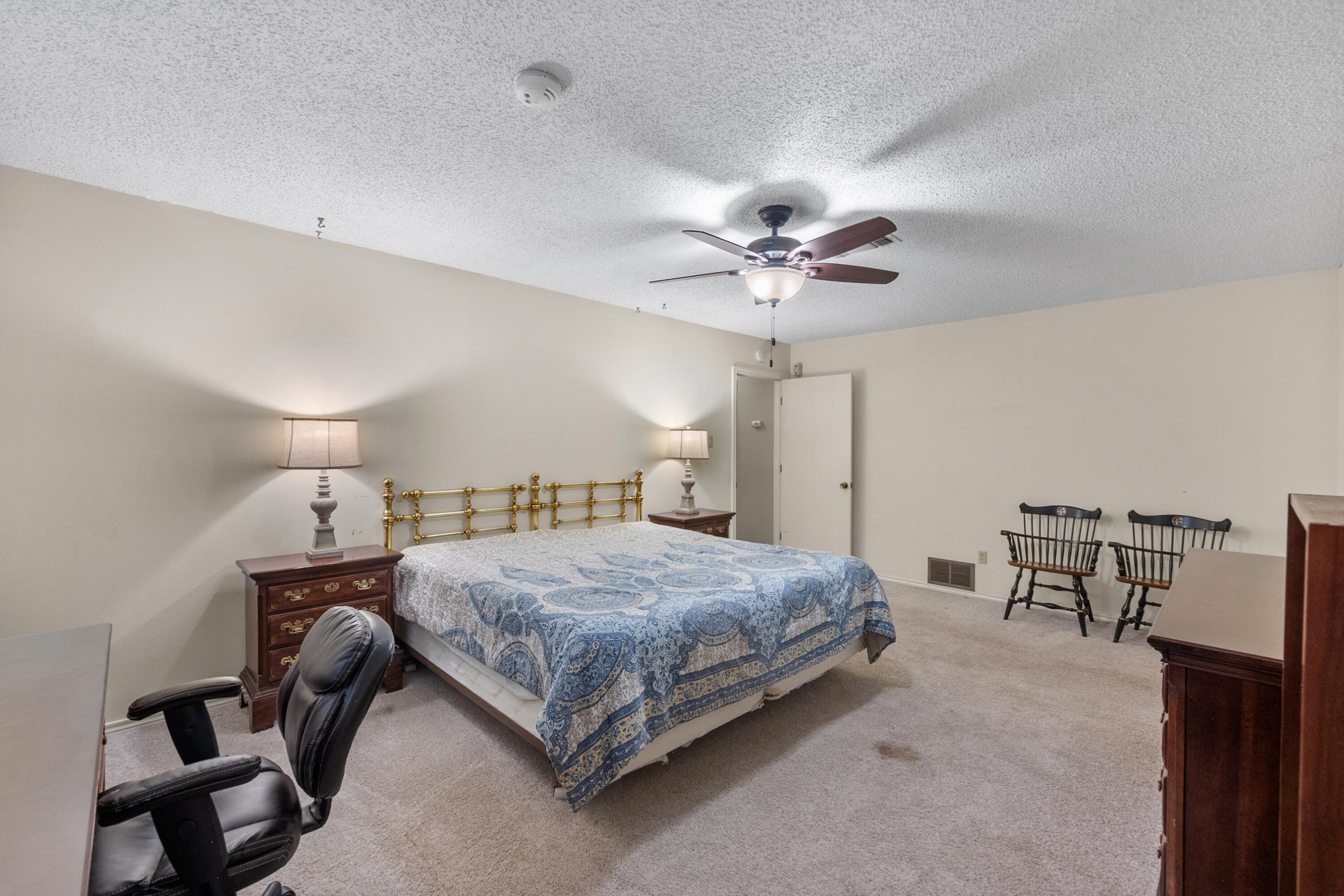 3801 66th Street Lubbock, TX 79413 - Photo 16 of 36 a bedroom with a bed a table and chair