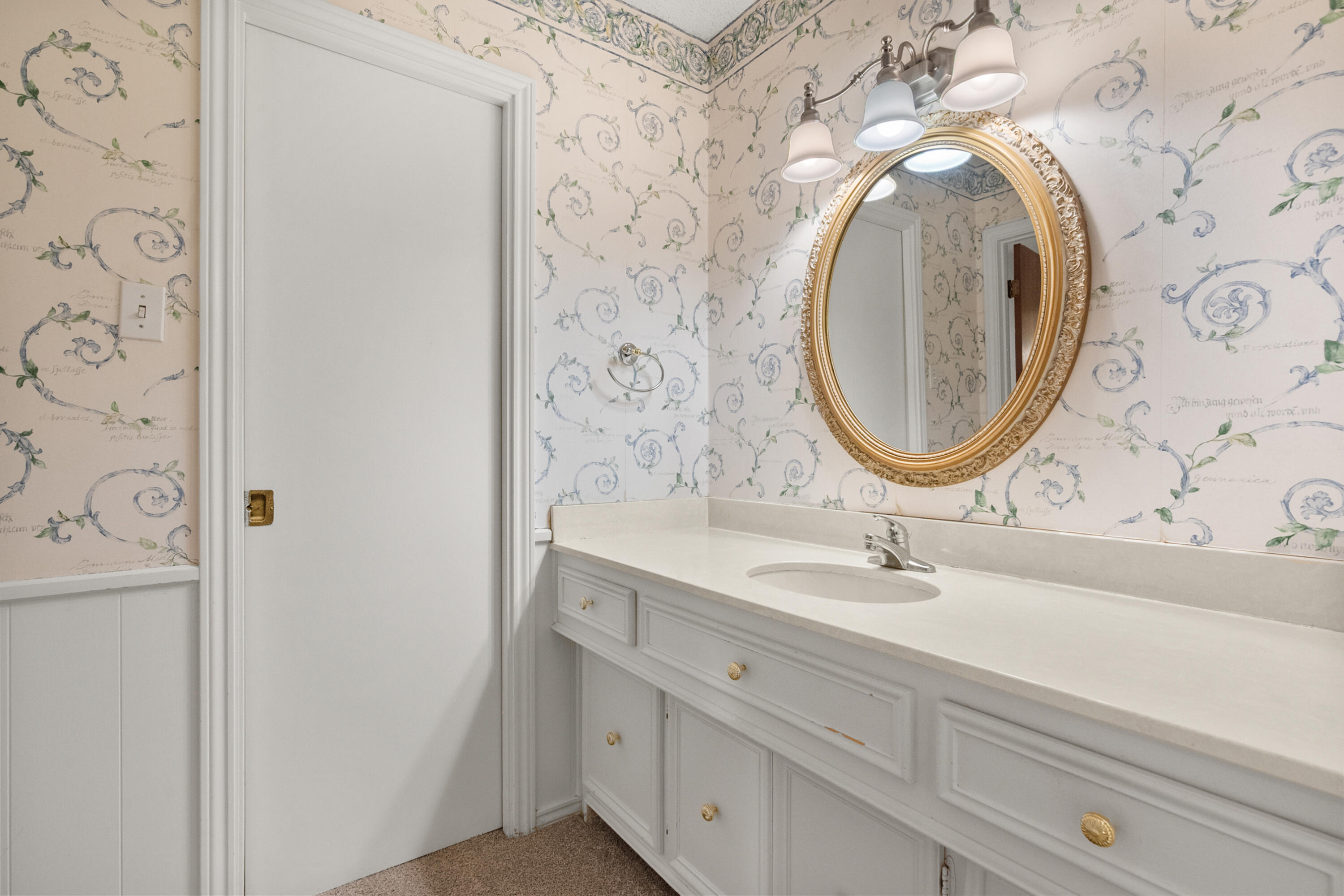 3801 66th Street Lubbock, TX 79413 - Photo 18 of 36 a bathroom with a sink and a mirror