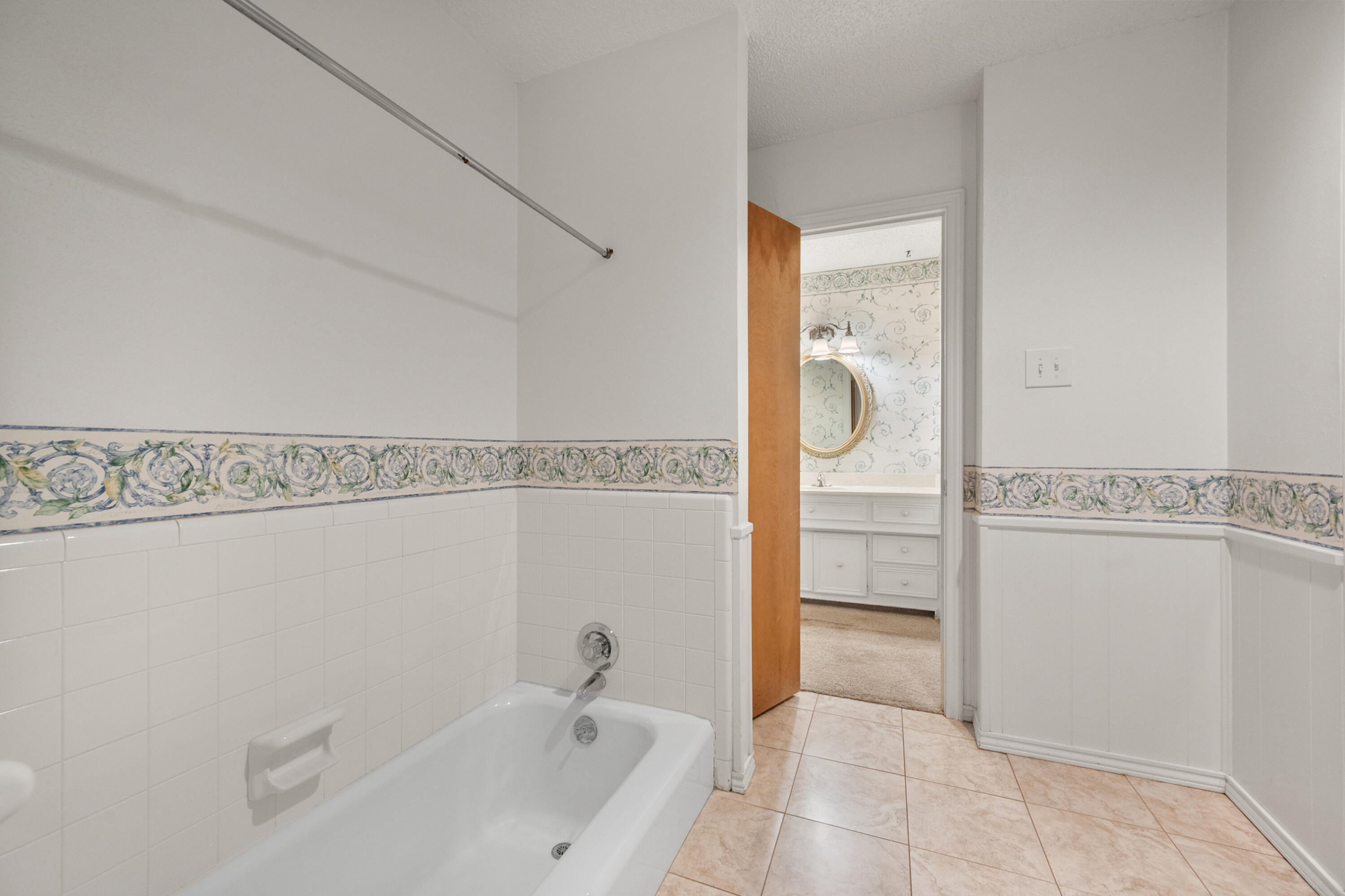 3801 66th Street Lubbock, TX 79413 - Photo 19 of 36 a bathroom with a sink and a mirror