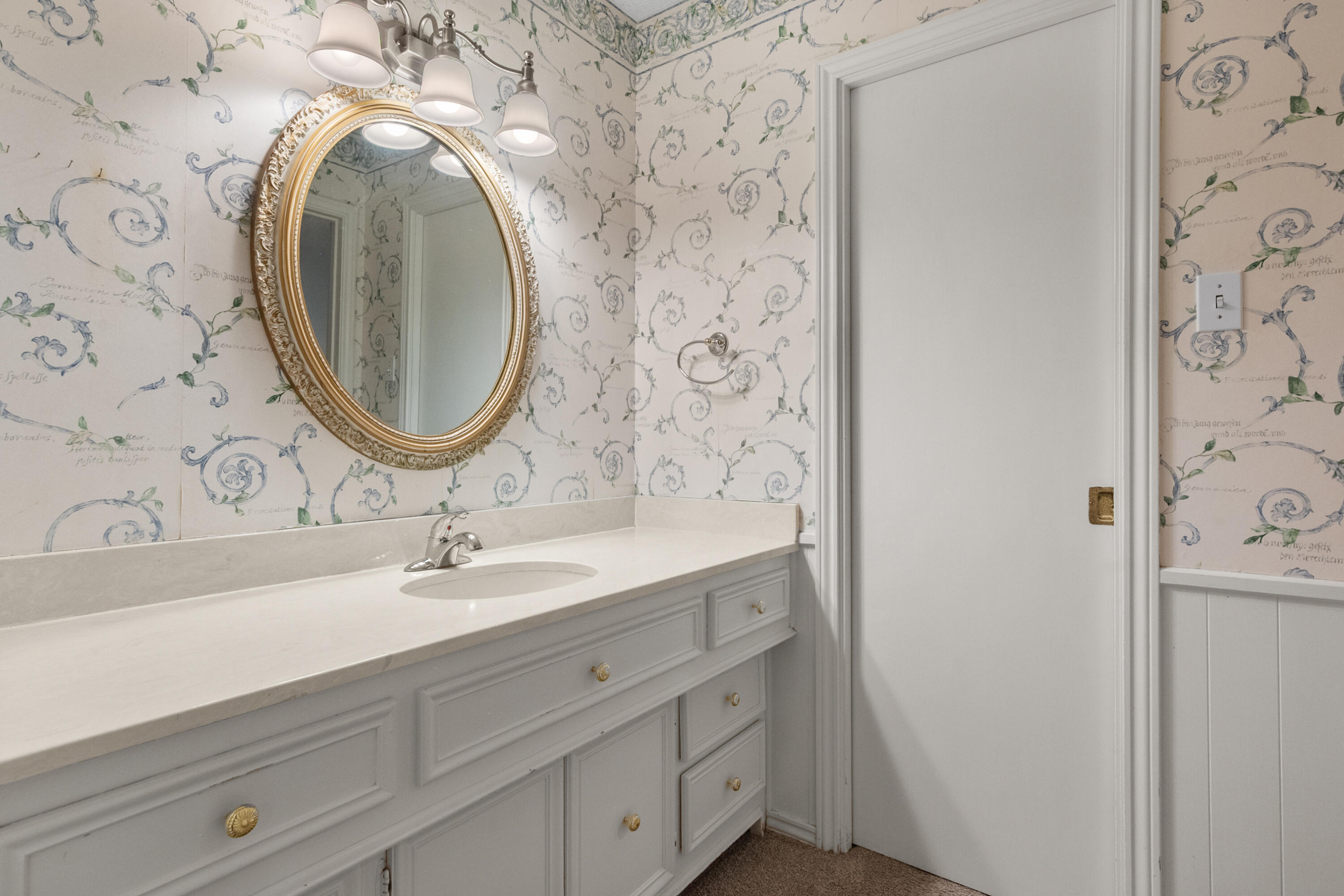 3801 66th Street Lubbock, TX 79413 - Photo 21 of 36 a bathroom with a sink and a mirror