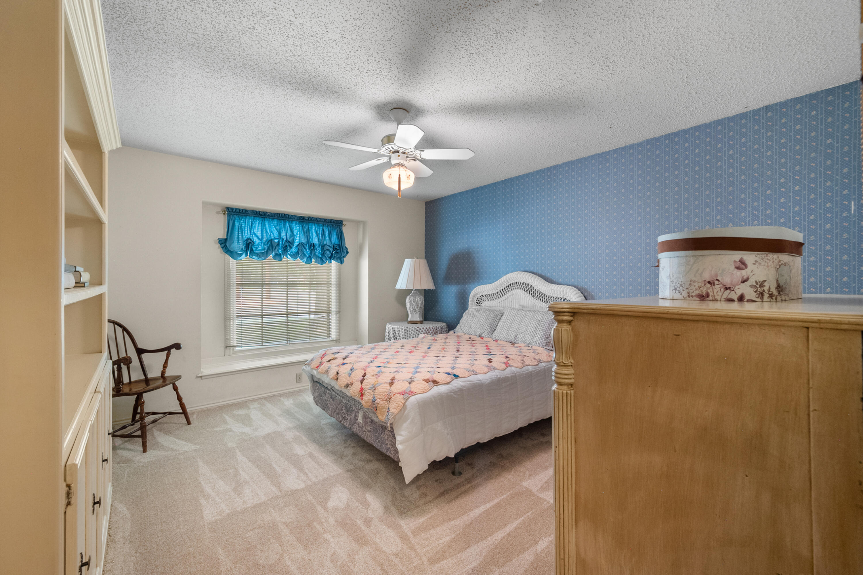 3801 66th Street Lubbock, TX 79413 - Photo 22 of 36 a spacious bedroom with a bed dresser and a window