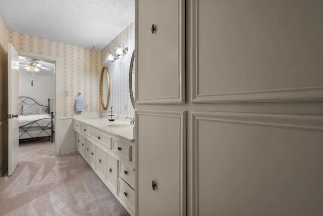 a en suite bathroom with a double vanity sink and a mirror