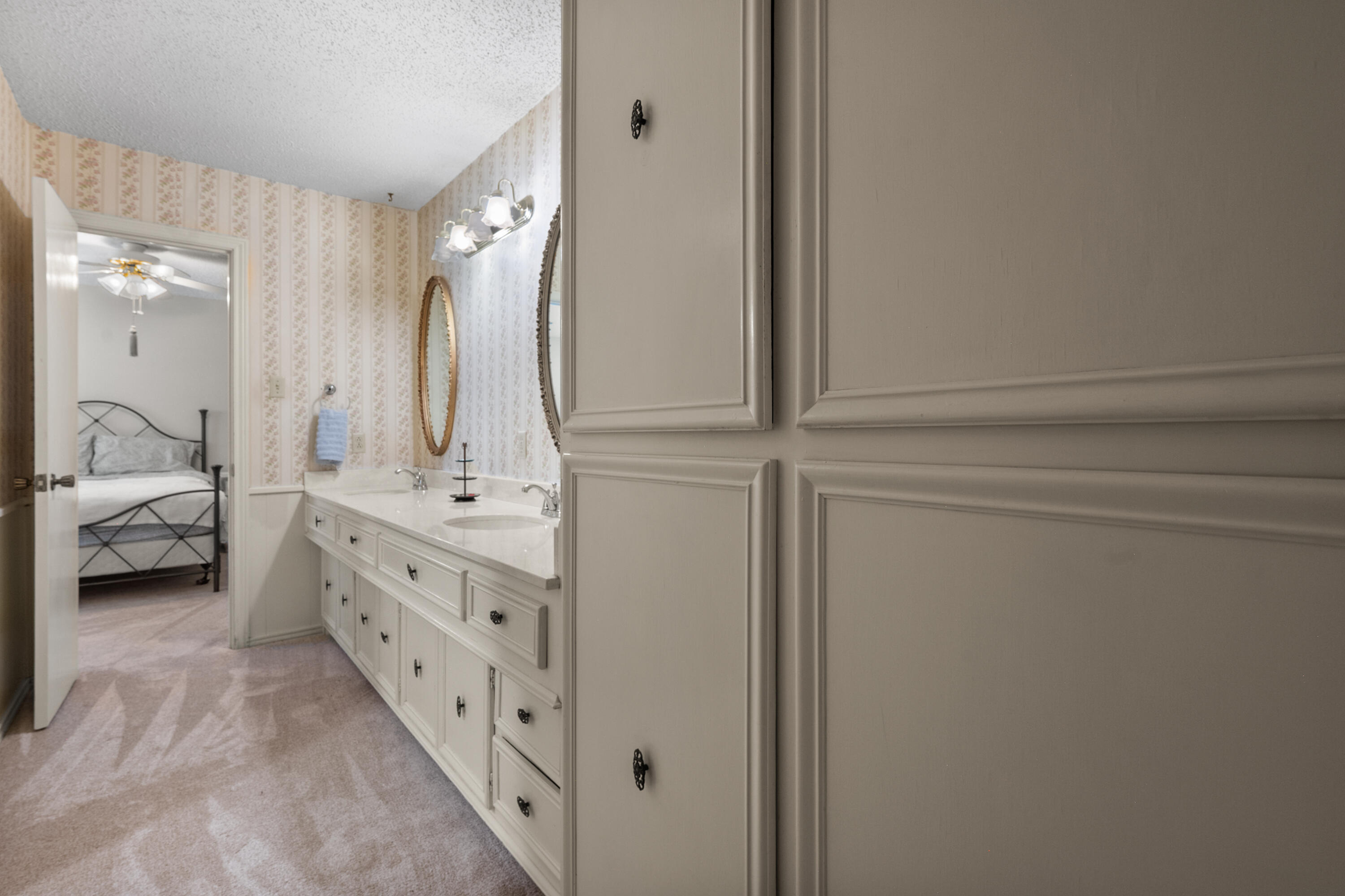3801 66th Street Lubbock, TX 79413 - Photo 23 of 36 a en suite bathroom with a double vanity sink and a mirror