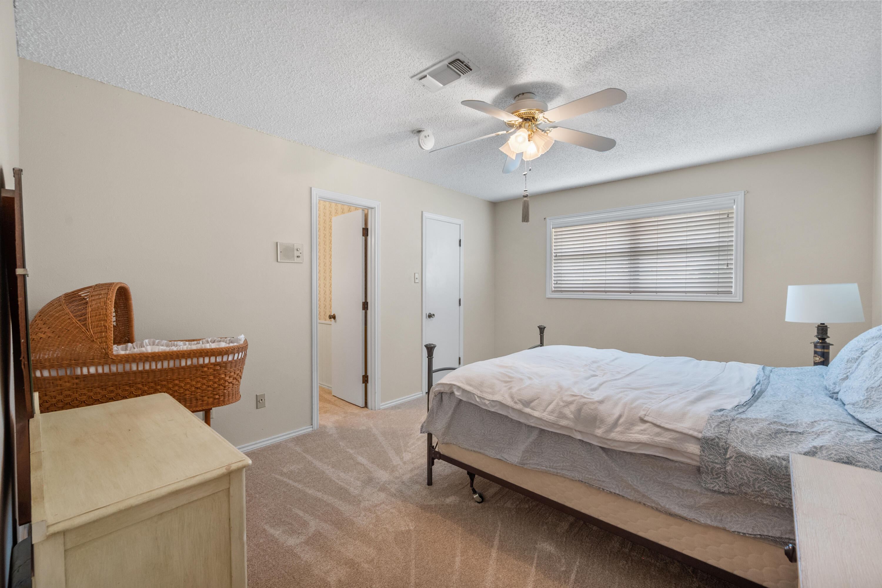 3801 66th Street Lubbock, TX 79413 - Photo 25 of 36 a bedroom with a bed and a chandelier