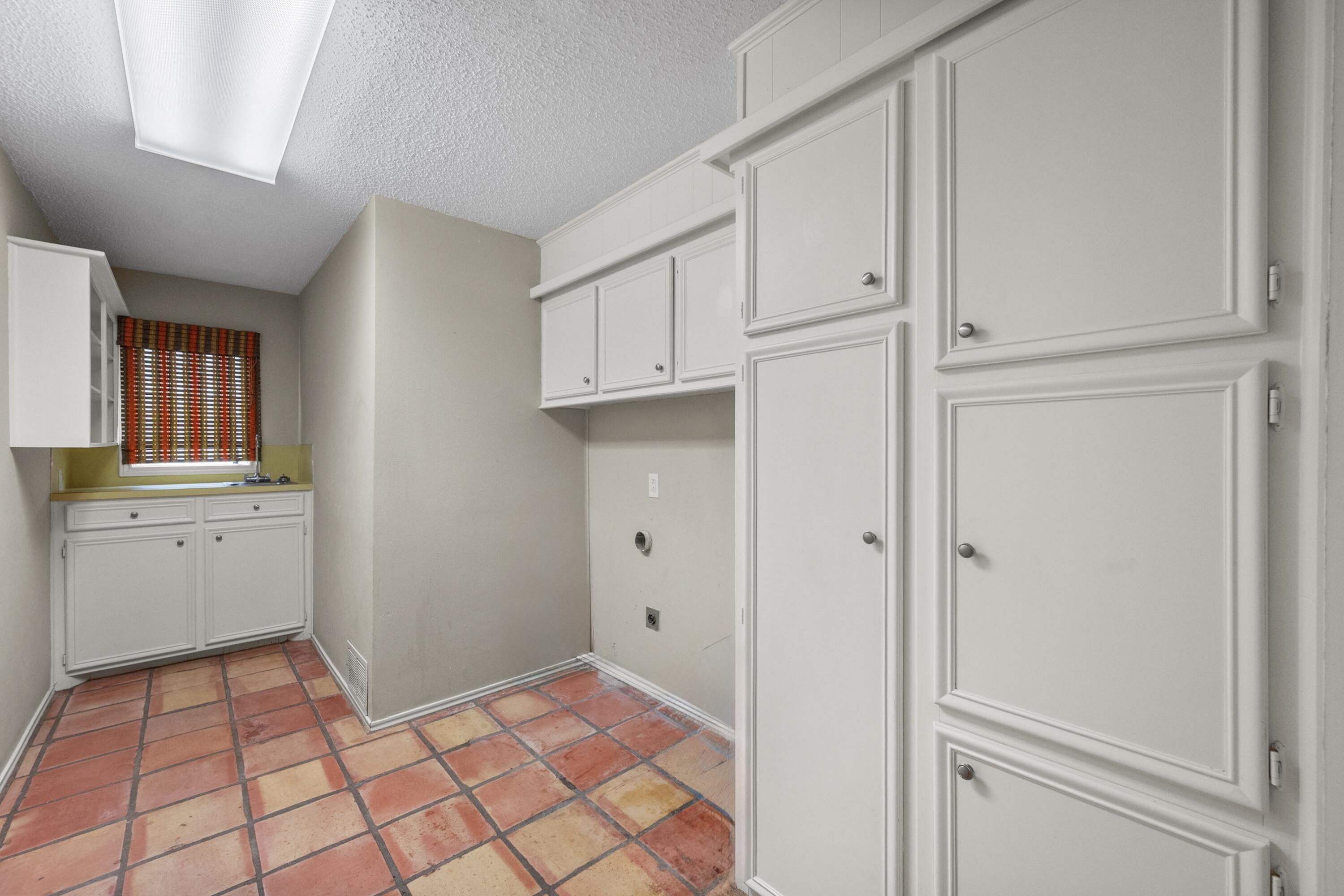 3801 66th Street Lubbock, TX 79413 - Photo 28 of 36 a room view with a wooden floor and white cabinets