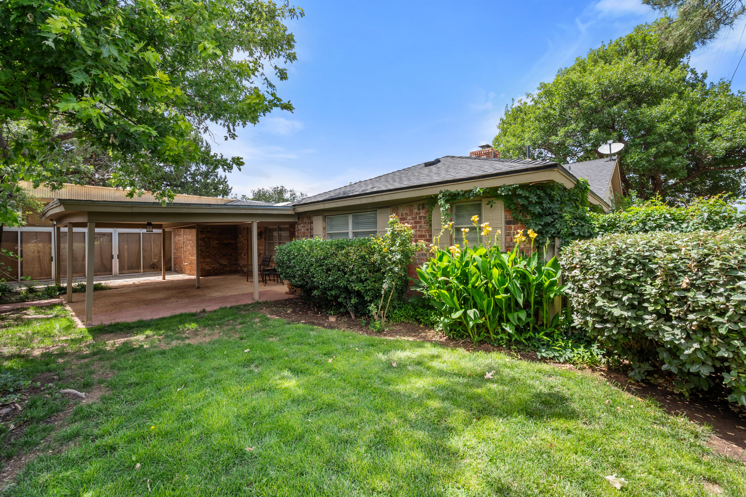 3801 66th Street Lubbock, TX 79413 - Photo 29 of 36 a front view of a house with a yard and porch