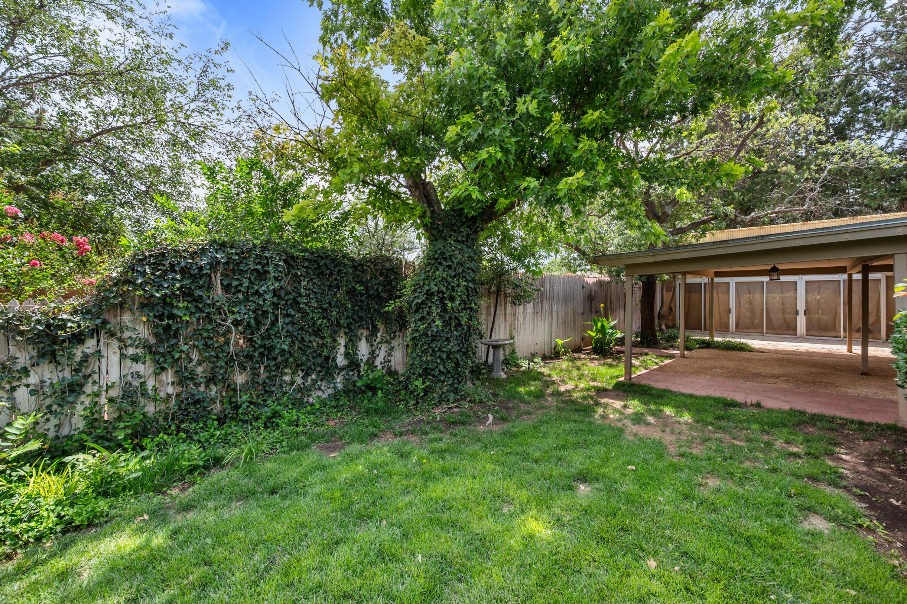 3801 66th Street Lubbock, TX 79413 - Photo 30 of 36 a view of a backyard with table and chairs and wooden fence