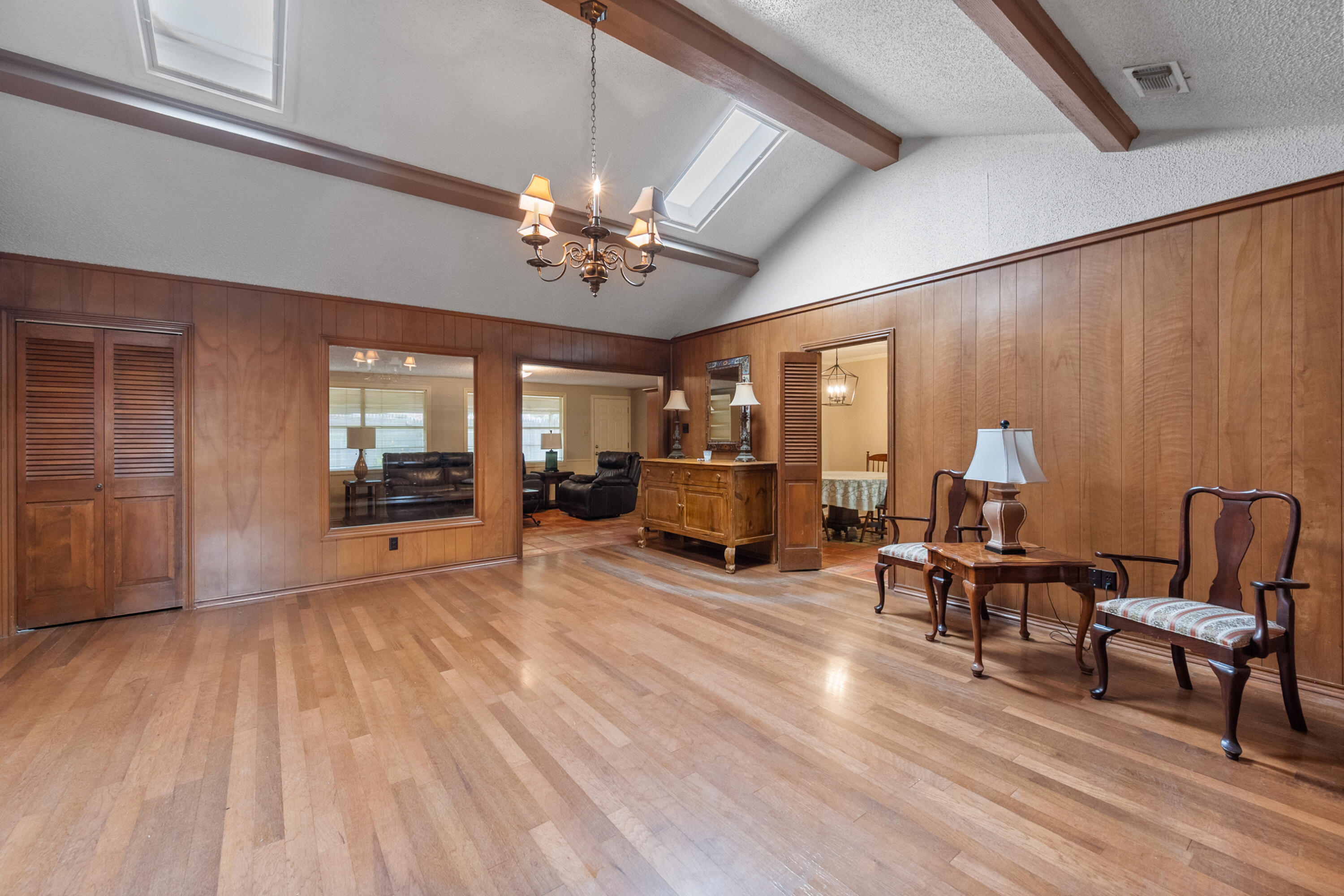 3801 66th Street Lubbock, TX 79413 - Photo 5 of 36 a view of a room with furniture a chandelier and wooden floor