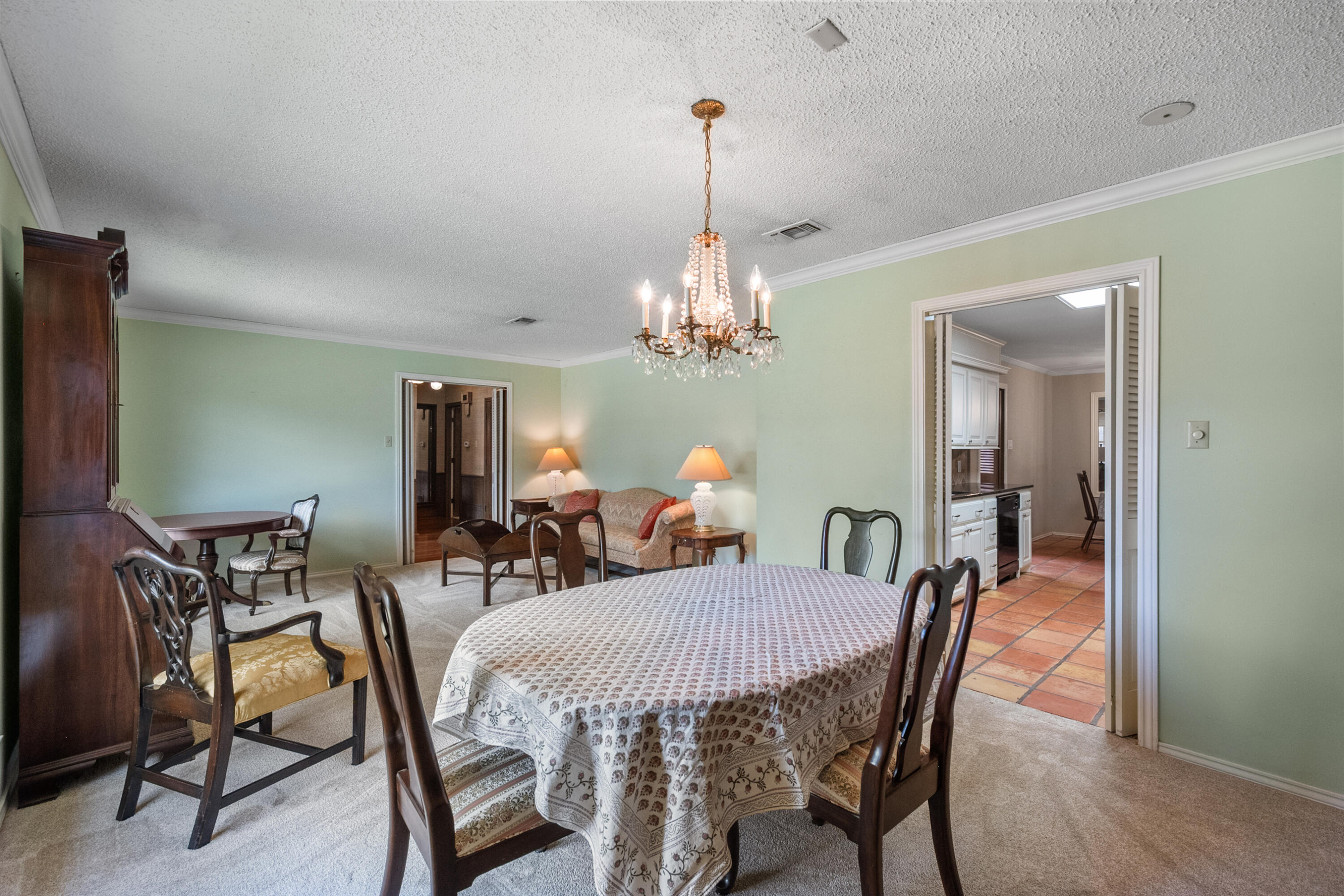 3801 66th Street Lubbock, TX 79413 - Photo 8 of 36 a view of a dining room with furniture and a chandelier