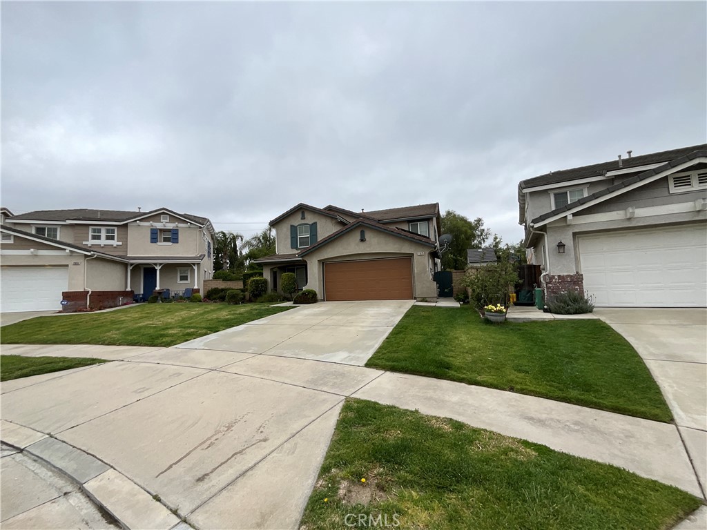 11875 Cedarbrook Place Rancho Cucamonga, CA 91730 - Photo 2 of 26 a front view of a house with a yard and garage