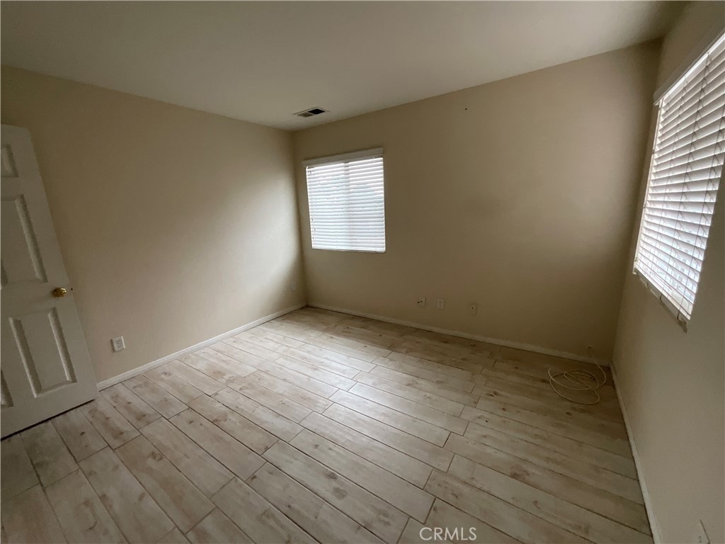 11875 Cedarbrook Place Rancho Cucamonga, CA 91730 - Photo 23 of 26 an empty room with wooden floor and windows