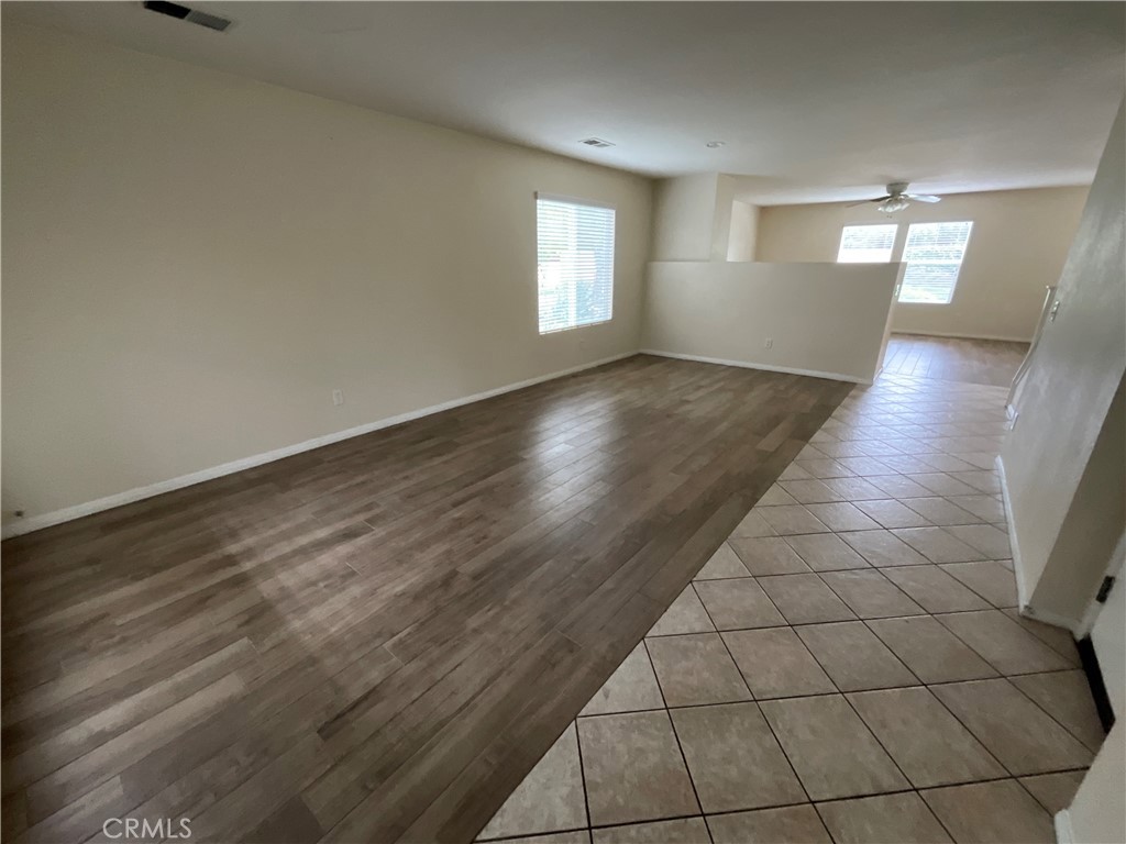 11875 Cedarbrook Place Rancho Cucamonga, CA 91730 - Photo 3 of 26 an empty room with wooden floor and windows