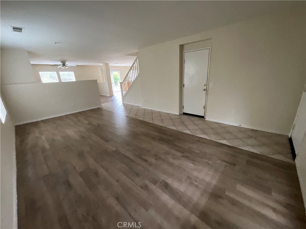 11875 Cedarbrook Place Rancho Cucamonga, CA 91730 - Photo 4 of 26 an empty room with wooden floor cabinet and windows