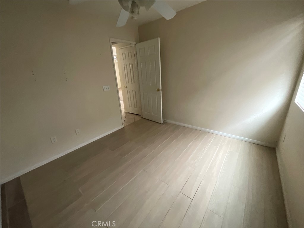 11875 Cedarbrook Place Rancho Cucamonga, CA 91730 - Photo 10 of 26 an empty room with wooden floor and windows