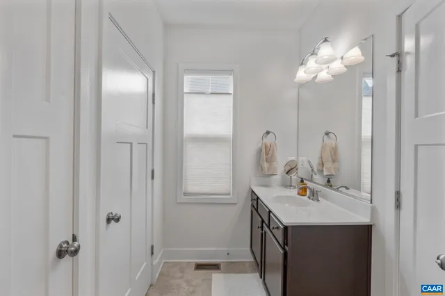 a bathroom with a sink vanity and a mirror