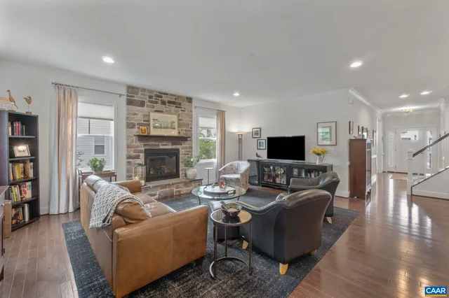 a living room with furniture flat screen tv and a fireplace
