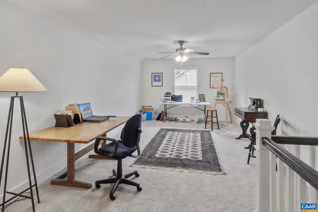 a bedroom with a bed a desk and chair