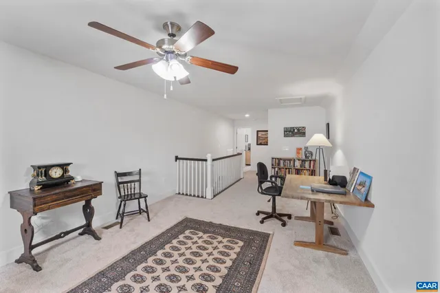 a bedroom with furniture and a rug