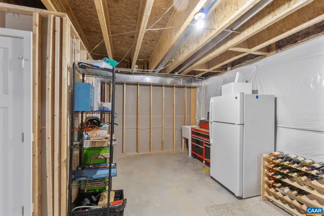 a bedroom with a bed and a lamp on dresser