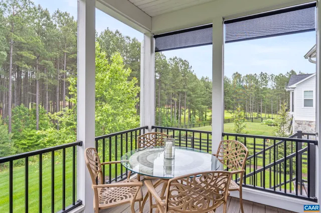 a living room with furniture a piano and a bookshelf