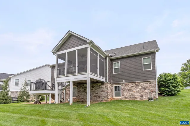 a front view of a house with a garden and yard