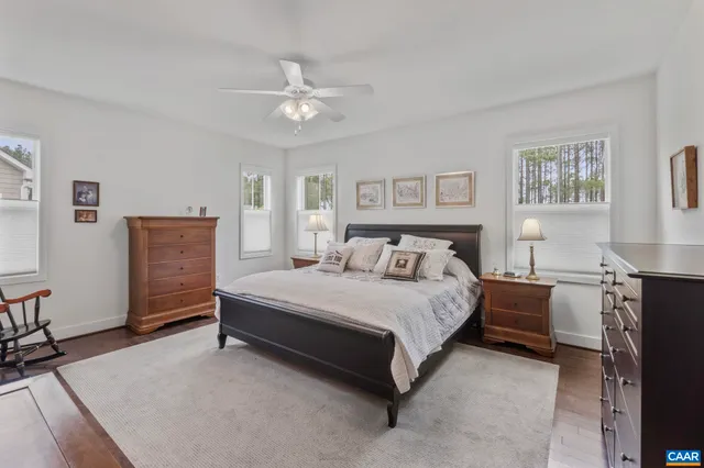a spacious bedroom with a bed and a chandelier