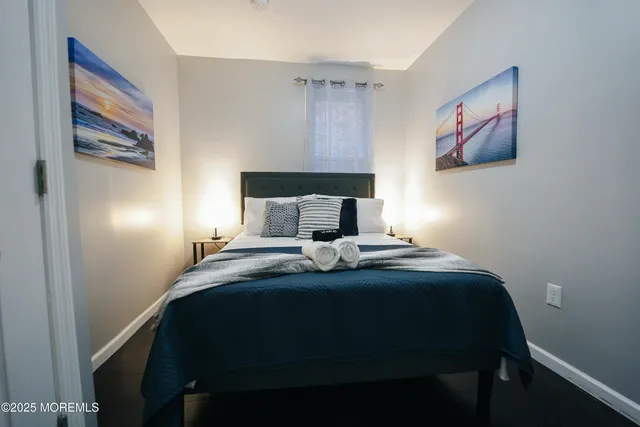 a bedroom with a bed and a painting on the wall