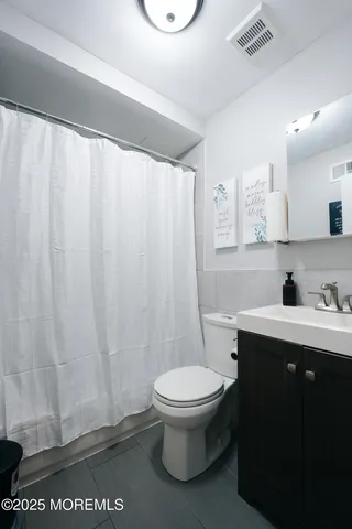 a bathroom with a toilet a sink and a shower
