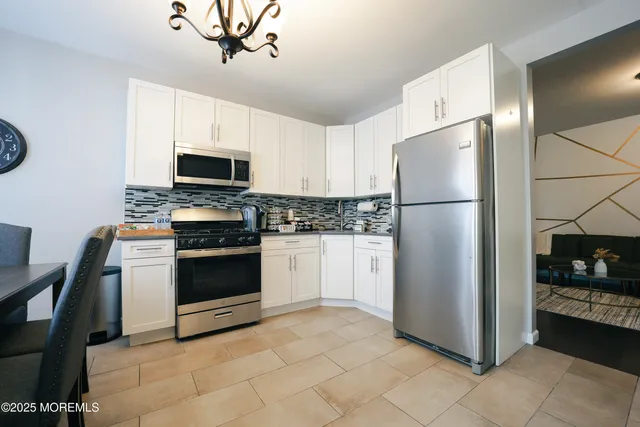 a kitchen with stainless steel appliances a refrigerator stove and microwave