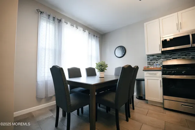 a view of a dining room with furniture and a window